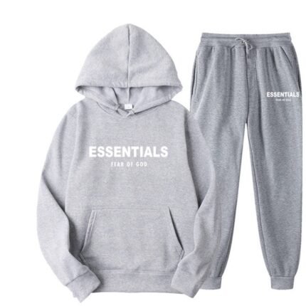 Grey sweatshirt and sweatpants set featuring the word "essentials" prominently displayed on the front.